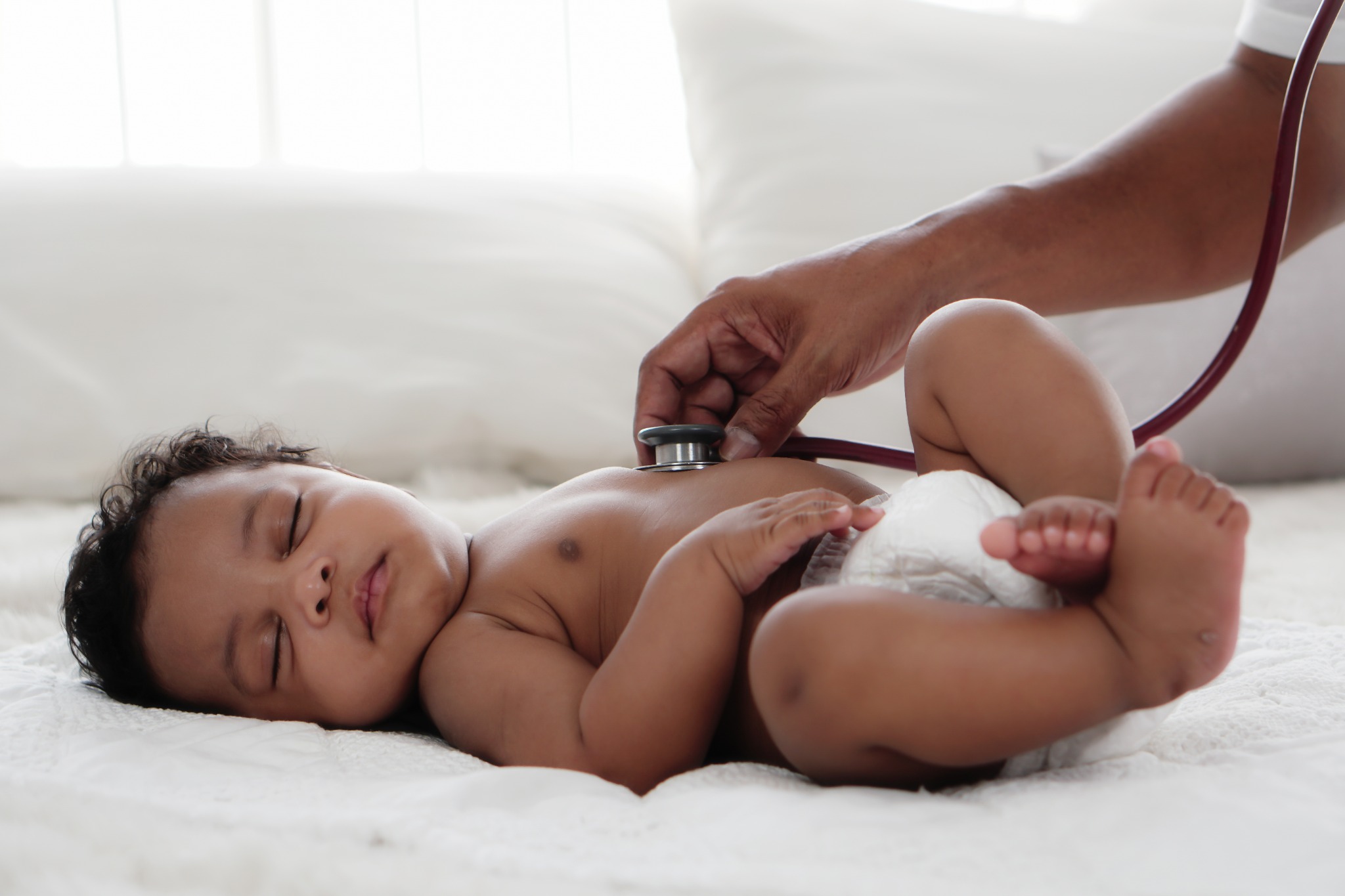 A newborn receiving a clinical examination